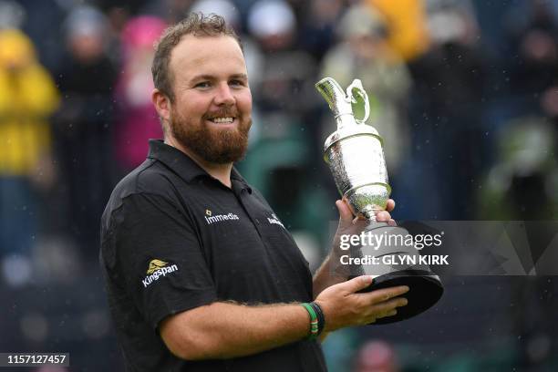 Ireland's Shane Lowry poses with the Claret Jug, the trophy for the Champion golfer of the year after winning the British Open golf Championships at...