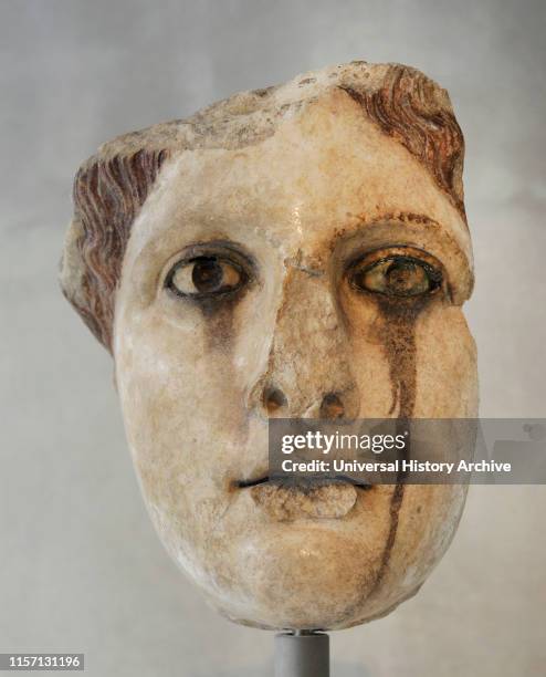 Head of female statue. A marble copy of a gold-and-ivory statue of the Classical period it represents a goddess, perhaps Aphrodite. The colour that...