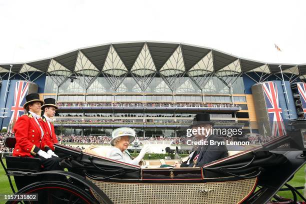 Queen Elizabeth II waves as she arrives on Ladies Day on day three of Royal Ascot at Ascot Racecourse on June 20, 2019 in Ascot, England.