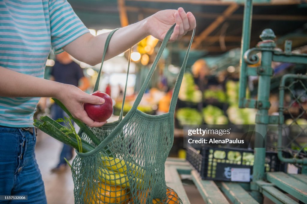 Fruits and Vegetables in a cotton mesh reusable bag, Zero Waste Shopping on Outdoors Market