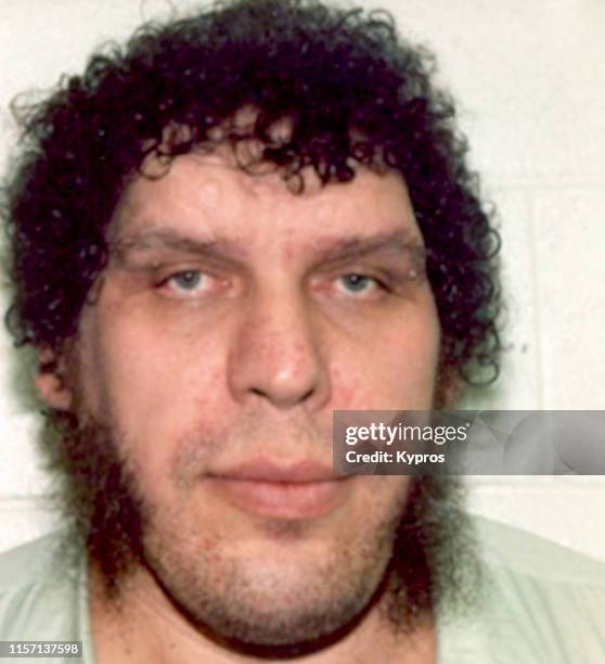 In this handout, French professional wrestler and actor Andre the Giant in a mug shot following his arrest charged with assault, Iowa, August 1989.