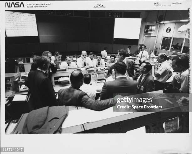 Group of flight controllers in the Missions Operations Control Room of the Mission Control Center at the Manned Spacecraft Center in Houston, Texas,...