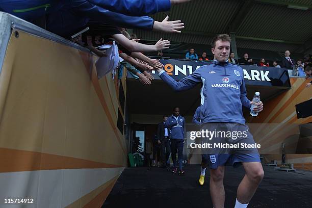 Phil Jones high fives local schoolkids as they walk out from the dressing rooms during the England U21's training session at Montjasa Park Stadium on...