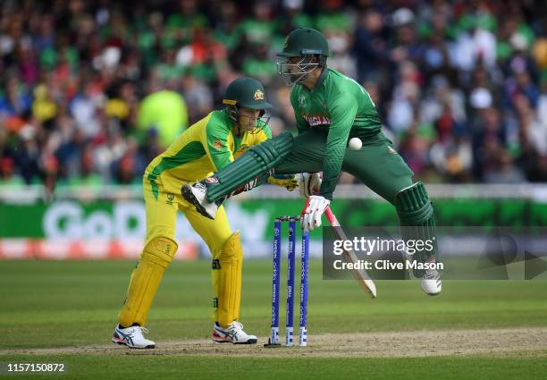 Tamim Iqbal of Bangladesh makes his ground but is hit by the ball during the Group Stage match of the ICC Cricket World Cup 2019 between Australia...