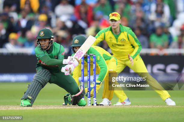 Mushfiqur Rahim of Bangladesh in action batting as Alex Carey of Australia looks on during the Group Stage match of the ICC Cricket World Cup 2019...