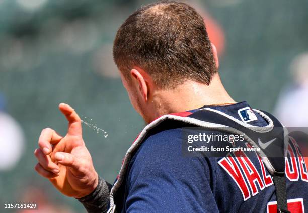 Boston Red Sox catcher Christian Vazquez wipes sweat off of his brow during the game between the Boston Red Sox and the Baltimore Orioles on July 21...