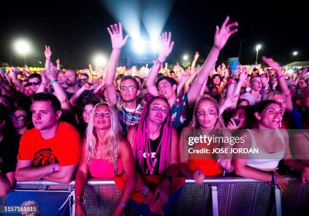 Revellers enjoy a performance on the fourth day of the Benicassim International Music Festival in Benicassim on July 21, 2019.