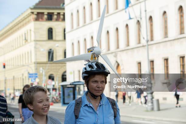 Wind turbine on a bike helmet. On July 21 more than ten thousand people demonstrated for a better climate policy and against the climate crisis in...