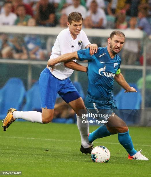 Vladimir Obukhov of FC Sochi vies for the ball with Branislav Ivanovic of FC Zenit Saint Petersburg during the Russian Premier League match between...