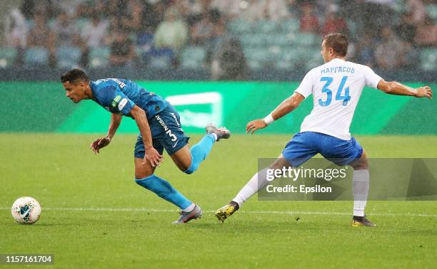 Timofei Margasov of FC Sochi vies for the ball with Douglas Santos of FC Zenit Saint Petersburg during the Russian Premier League match between FC...