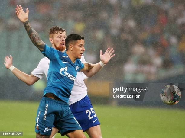 Ivan Novoseltsev of FC Sochi vies for the ball with Sebastian Driussi of FC Zenit Saint Petersburg during the Russian Premier League match between FC...