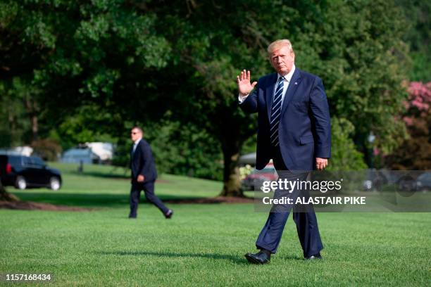 President Donald Trump waves as he returns to the White House in Washington, DC, on July 21, 2019. - Trump is returning to Washington after spending...