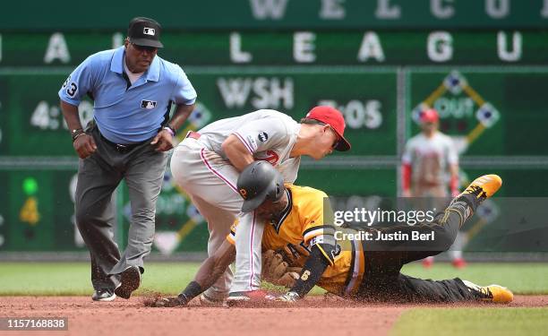 Starling Marte of the Pittsburgh Pirates is tagged out at second base by Scott Kingery of the Philadelphia Phillies in the sixth inning during the...