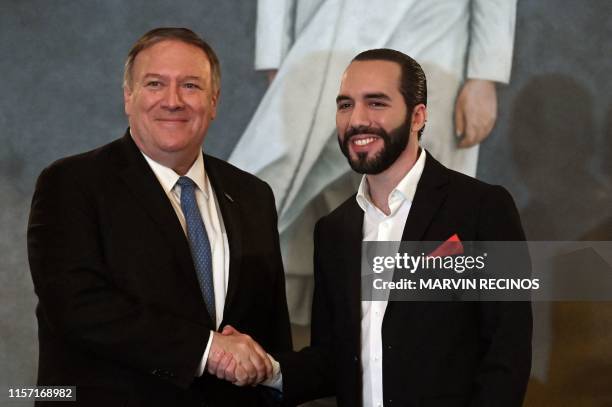 Secretary of State Mike Pompeo shakes hands with Salvadorean President Nayib Bukele after signing bilateral agreements at the presidential residence...