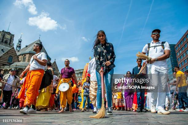 Woman sweeps the street as she takes part during the ceremony. The Festival of the Chariots, also known as Ratha Yatra, is a timeless festival,...