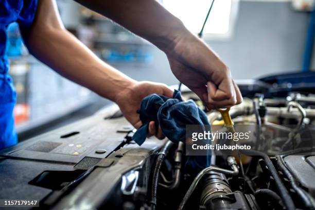 checking oil in car engine - grease imagens e fotografias de stock