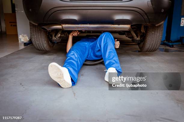 auto mechanic working on a car engine in repair shop. - below stock pictures, royalty-free photos & images