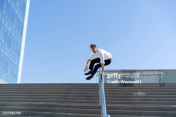 businessman crossing banister in the city - spring city break stock pictures, royalty-free photos & images