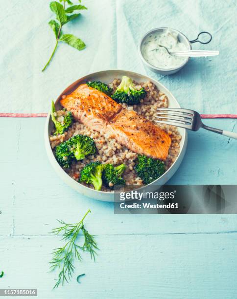fried salmon with buckwheat pilaf and broccoli in a bowl - vegetable fried rice stock-fotos und bilder