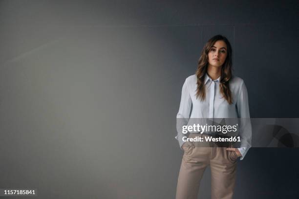 portrait of serious young businesswoman - grey blouse stock pictures, royalty-free photos & images