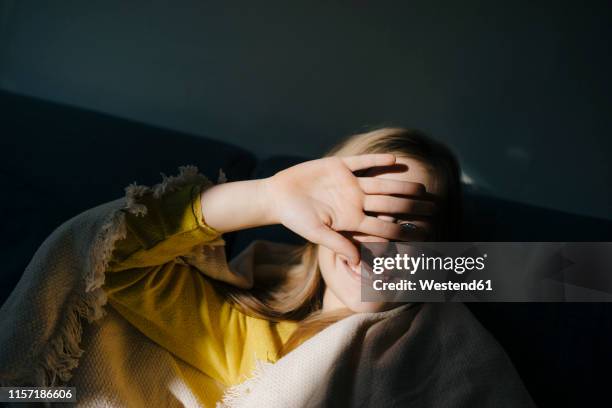 girl at home shielding her eyes from sunshine - shielding eyes stock pictures, royalty-free photos & images