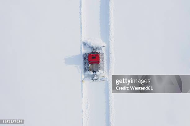 austria, tyrol, galtuer, view to ski slope and snow groomer in winter, aerial view - sneeuwschuiver stockfoto's en -beelden