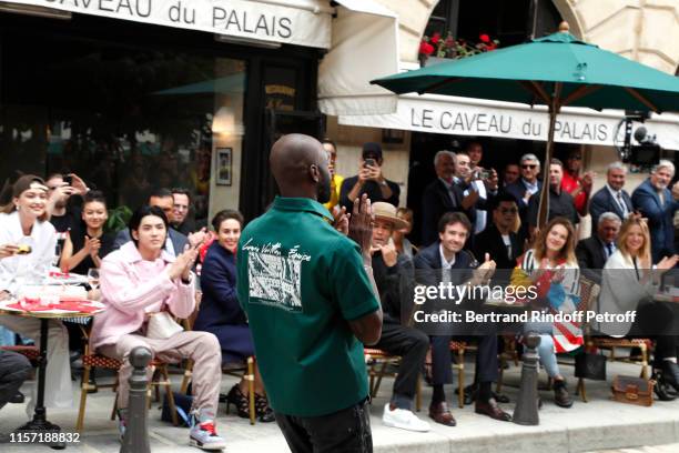 Stylist Virgil Abloh acknowledges the applause of the audience in front of Gigi Hadid, Kris Wu, Jaclyn Matfus, Ben Harper, General manager of Berluti...