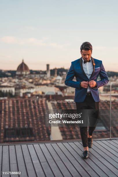italy, florence, stylish man on roof terrace at sunset - menswear bildbanksfoton och bilder
