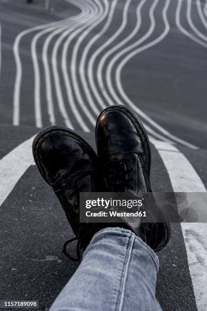 denmark, copenhagen, woman's black boots on tarmac - black boot foto e immagini stock