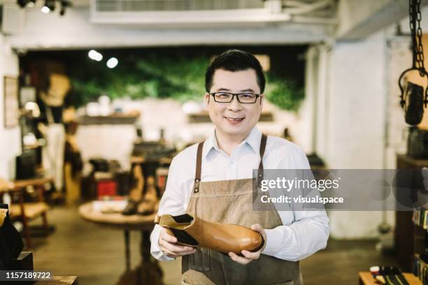 portrait of small business owner in his store - shoe shop assistant stock pictures, royalty-free photos & images