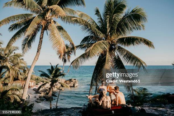 mexico, quintana roo, tulum, friends relaxing on the beach - tulum mexico stockfoto's en -beelden