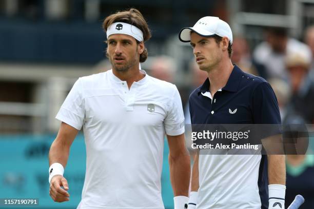 Andy Murray of Great Britain speaks with playing partner Feliciano Lopez of Spain during his First Round Doubles match against Juan Sebastian Cabal...
