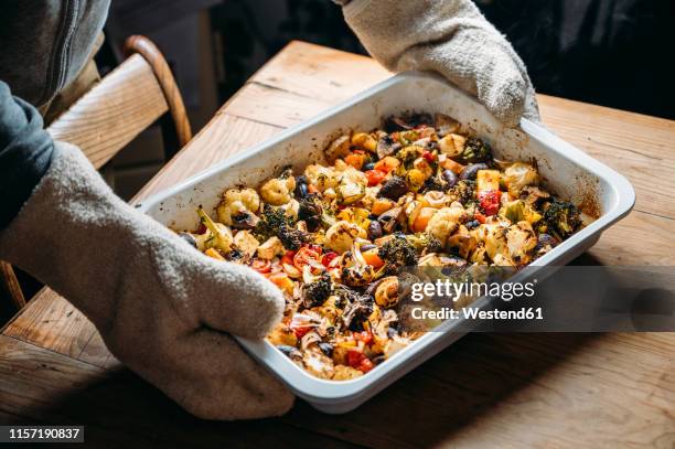 baked vegetables with feta cheese in a baking pan - casserole stock-fotos und bilder