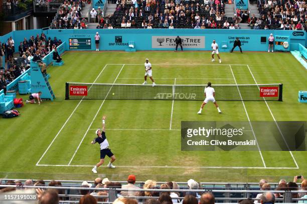 Andy Murray of Great Britain, partner of Feliciano Lopez of Spain serves during his First Round Doubles match against Juan Sebastian Cabal and Robert...