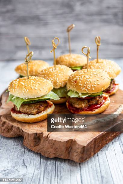 mini-burger with mincemeat, salad, cucumber and tomato on wooden tray - little burger stock pictures, royalty-free photos & images