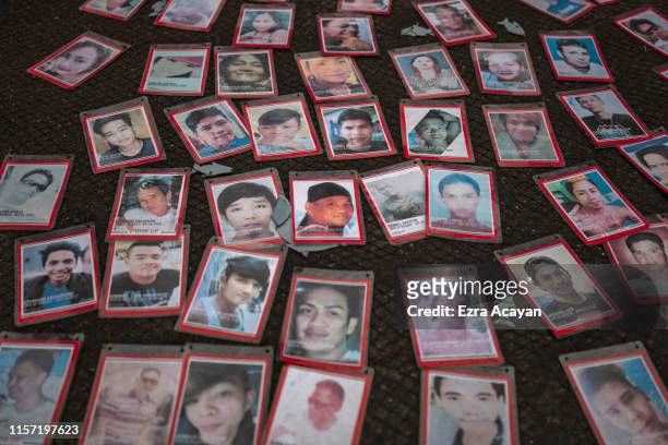 Pictures of people killed in the drug war are laid on the ground during a protest outside the Philippine congress where President Rodrigo Duterte...