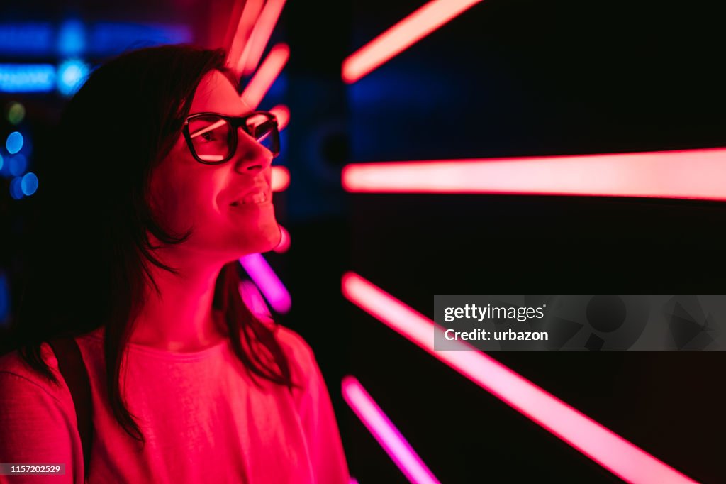 Curious woman and neon lights