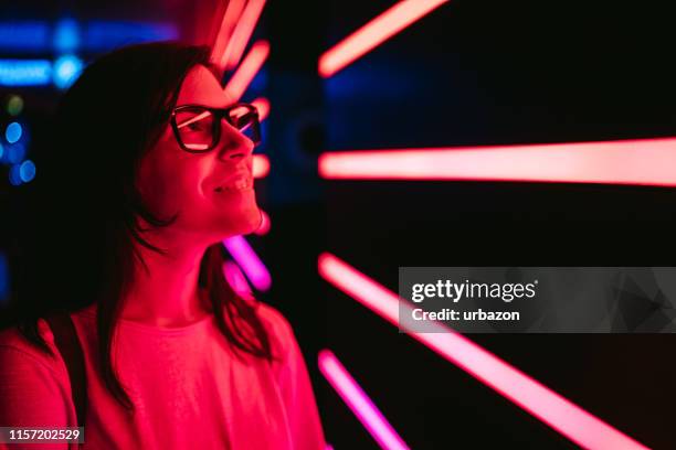 curious woman and neon lights - curiosity abstract stock pictures, royalty-free photos & images