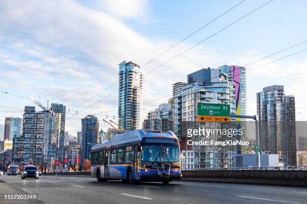 public bus at granville street bridge downtown vancouver - vancouver canada 2019 stock pictures, royalty-free photos & images