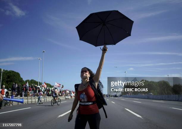 Woman whose T'shirt reads "resistance" walks down the Las Americas Highway in San Juan, Puerto Rico, July 22, 2019 on day 9th of continuous protests...
