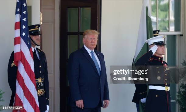 President Donald Trump waits to greet Imran Khan, Pakistans prime minister, not pictured, outside the White House in Washington, D.C., U.S., on...