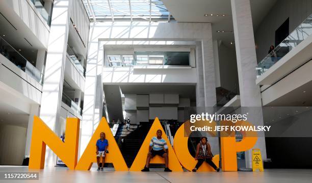 People pose in the atrium at the NAACPs 110th National Convention at Cobo Center on July 22, 2019 in Detroit, Michigan.