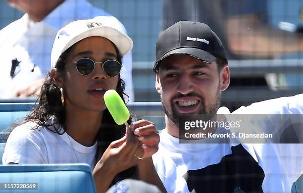 Klay Thompson of the Golden State Warriors and actress Laura Harrier attend the Los Angeles Dodgers and Miami Marlins baseball game at Dodger Stadium...