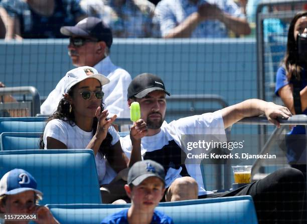 Klay Thompson of the Golden State Warriors and actress Laura Harrier attend the Los Angeles Dodgers and Miami Marlins baseball game at Dodger Stadium...