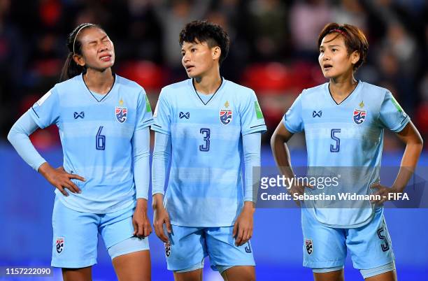 Pikul Khueanpet, Natthakarn Chinwong and Ainon Phancha of Thailand look dejected in defeat after the 2019 FIFA Women's World Cup France group F match...