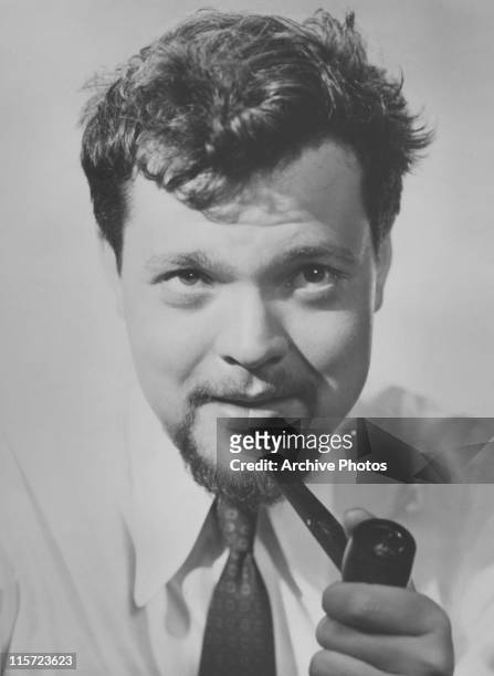 Orson Welles , US film director, actor, theatre director, screenwriter, and producer, holding a pipe, USA, circa 1935.