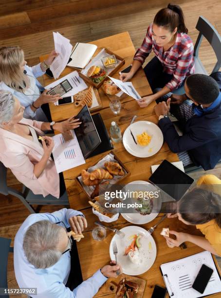 team of happy business colleagues on a meeting  in restaurant - smart casual lunch stock pictures, royalty-free photos & images