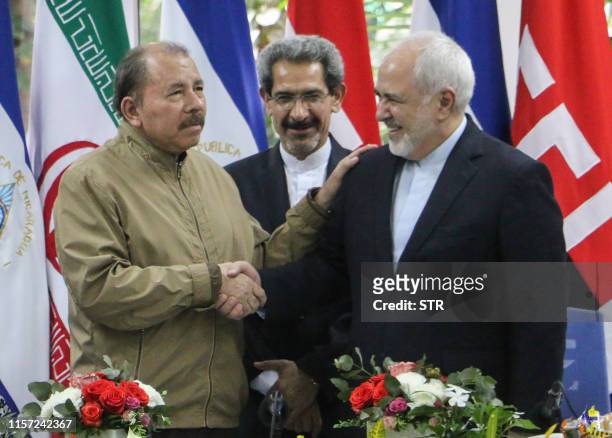 Nicaraguan President Daniel Ortega and Iran's Foreign Minister Mohammad Javad Zarif shake hands during a meeting in Managua on July 22, 2019. - Zarif...