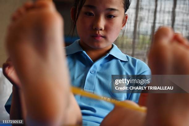 This photo taken on June 23, 2019 shows young Japanese karate competitor Mahiro Takano training in Nagaoka, Niigata Prefecture. - The petite...