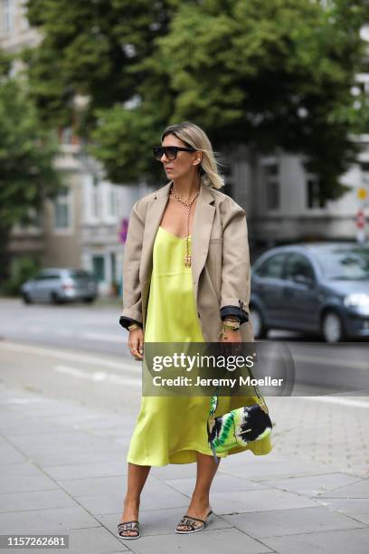 Aylin Koenig wearing The Frankie Shop blazer, Chanel shoes, Prada bag, Arket dress, Celine Sunglasses on June 20, 2019 in Hamburg, Germany.